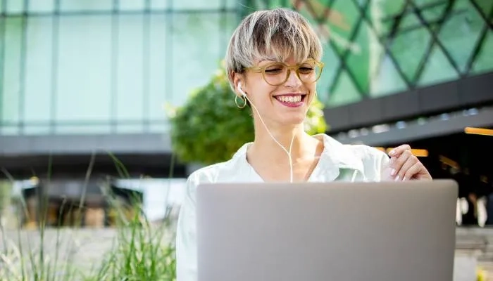 Women sat outside working on a laptop